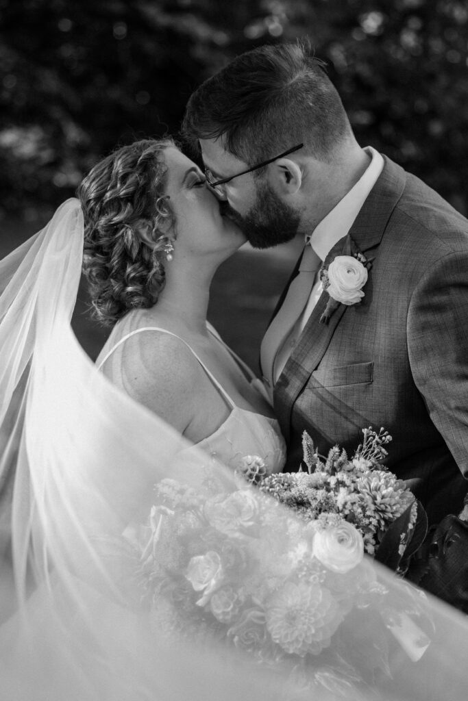 couple kissing at glen magna farms wedding