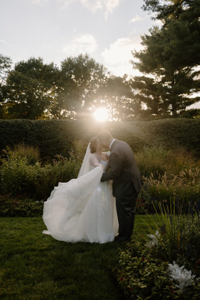bride and groom during golden hour posing for their ​glen magna farms wedding photography