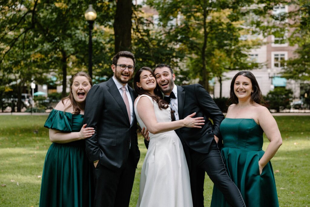 Family poses for photos at a wedding in Boston Public Garden. 
