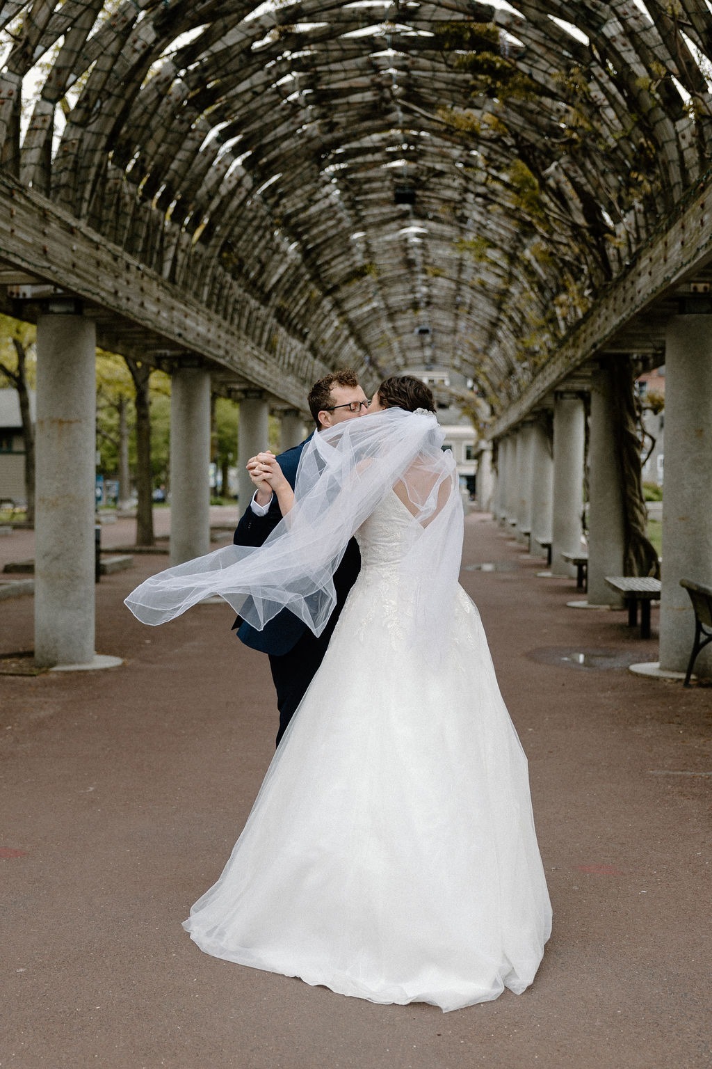 Bride and groom taking portraits outside a historic Boston wedding venue